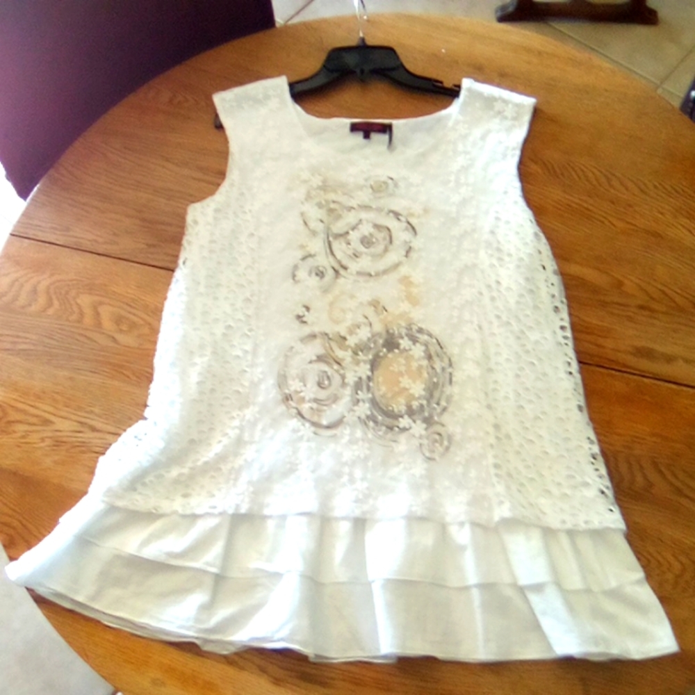 Lulu Love White Lacey Sleeveless Blouse with Artsy Design and Ruffle Trim.